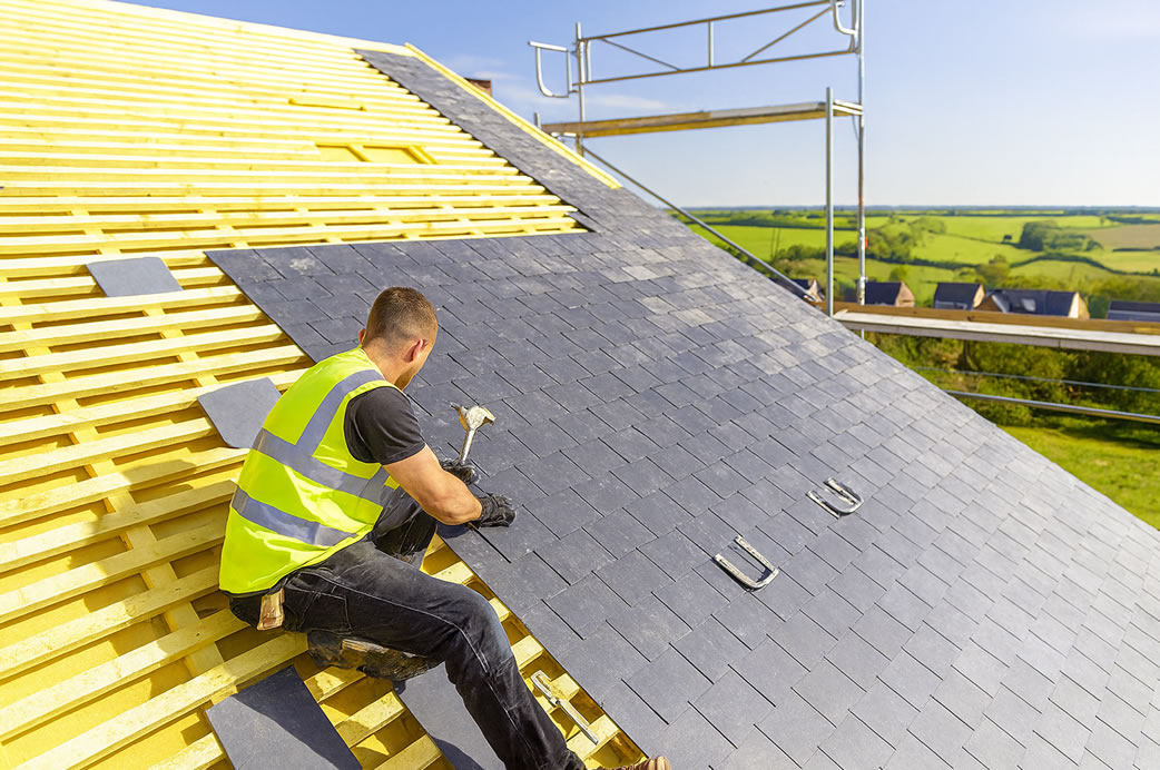 Professional roofing crew installing a new roof on a residential property